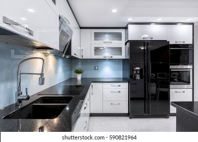 Modern and elegant kitchen with black and white furniture - Powered by Shutterstock