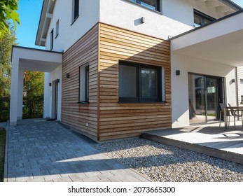 Modern elegant pattern house with wood paneling, finished house, garden and veranda.