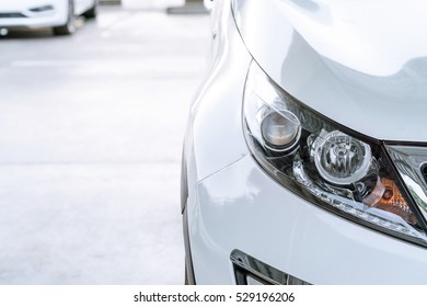 Modern And Elegant White Car - Closeup Of Car Headlight With Copy Space

