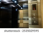 The modern elevator has a stylish control panel and elegant wood accents for function and beauty