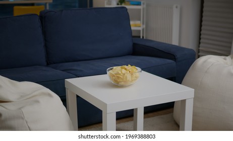 Modern Empty Apartament With Nobody In It Is Ready For Night Party Having Chips Bowl On Woden Table. Living Room Is Prepared For Friends Gathering Celebrating Wekeend Birthday Party Late At Night