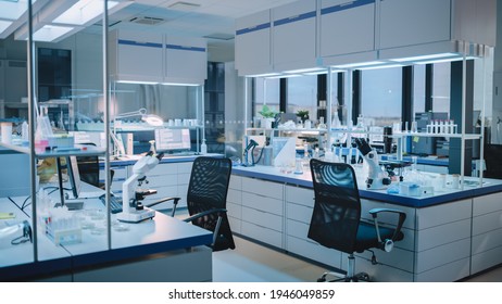 Modern Empty Biological Applied Science Laboratory with Technological Microscopes, Glass Test Tubes, Micropipettes and Desktop Computers and Displays. PC's are Running Sophisticated DNA Calculations.