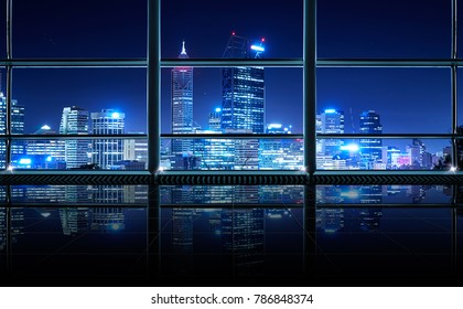 Modern empty and clean office interior with glass windows , Perth city skyline background , night scene .