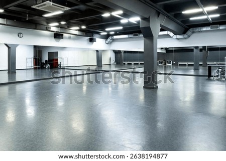 Modern empty dance studio with mirrors and industrial ceiling – spacious fitness hall for choreography, group workouts, or rehearsals in contemporary interior, professional training facility

