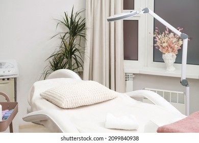 Modern empty dermatologist cosmetologist massage table for cosmetic procedures in the beauty clinic. Empty aesthetic medicine salon - Shutterstock ID 2099840938