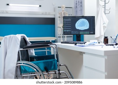 Modern Empty Hospital Office Having Computer With Brain Radiography On Screen Ready For Oncology Examination. Cabinet Room Equipped With Medical Professional Tools. Brain Tomography Image