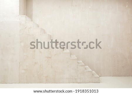 Modern empty room in loft style with concrete floor. Studio with contemporary interior design and stairs on copy space wall