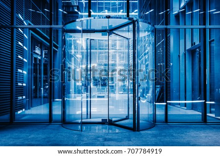 modern entrance with revolving door,blue toned.