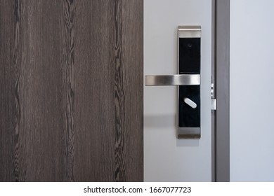 Modern Entrance Wooden Door With Metal Doorknob Handle And Security Electronic Digital Door Keycard Lock Systems For Good Safety Of Apartment Door