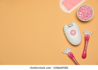 Modern Epilator And Other Hair Removal Products On Orange Background, Flat Lay. Space For Text