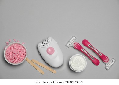 Modern Epilator And Other Hair Removal Products On Light Grey Background. Space For Text