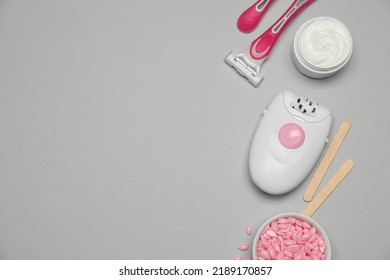 Modern Epilator And Other Hair Removal Products On Light Grey Background. Space For Text