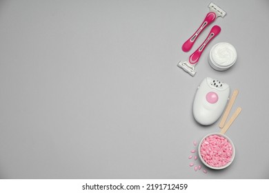 Modern Epilator And Other Hair Removal Products On Light Grey Background. Space For Text