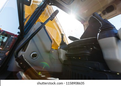 Modern Ergonomic And Stylish Dashboard Of Heavy Semi Truck With Lots Of Equipment, Steering Column, Indicators, Buttons, And Other Electronics, Integrated Into Interior Of Large Commercial Truck Cab.