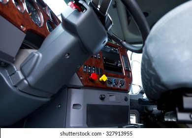 Modern Ergonomic And Stylish Dashboard Of Heavy Semi Truck With Lots Of Equipment, Steering Column, Indicators, Buttons, And Other Electronics, Integrated Into Interior Of Large Commercial Truck Cab.