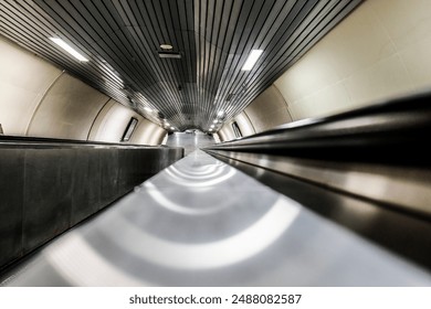 A modern escalator with sleek design in an underground subway station, captured in a wideangle shot - Powered by Shutterstock