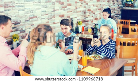 Similar – Image, Stock Photo Young friends looking map with healthy drinks and snacks