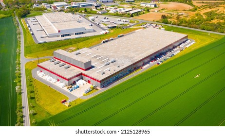 Modern European Industry With Low Carbon Footprint. Industrial Buildings In Green Fields. Technology Park And Factories  From Above.