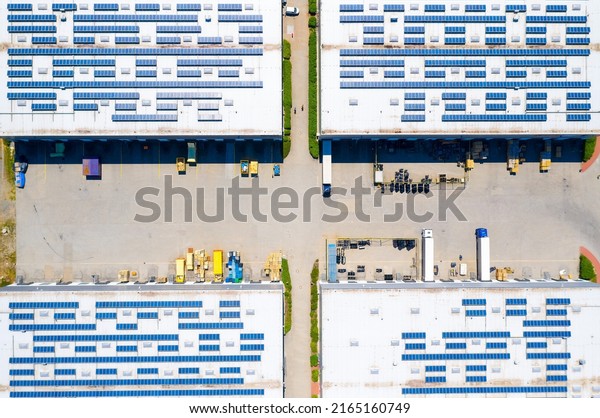 Modern European industry with low carbon
footprint. Industrial warehouse with solar panels. Technology park
and factories  from
above.