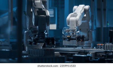 Modern EV Factory. On Automated Production Line Robot Arms Transporting Automotive Battery Modules onto Conveyor Belt. Electric Car Battery Pack Manufacturing Process.