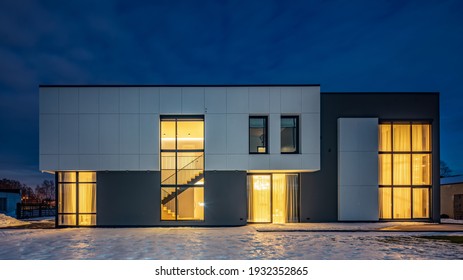 Modern Exterior Of Luxury Cottage. Private House In Scandinavian Style At Winter Evening.