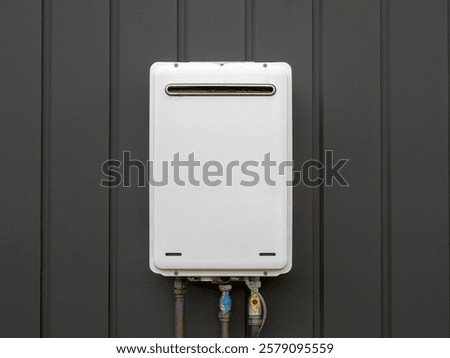 Modern external continuous flow gas water heater mounted on house wall