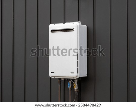 Modern external continuous flow gas water heater mounted on house wall 