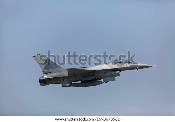 Modern F-16 Fighter\
Plane Above the Clouds 