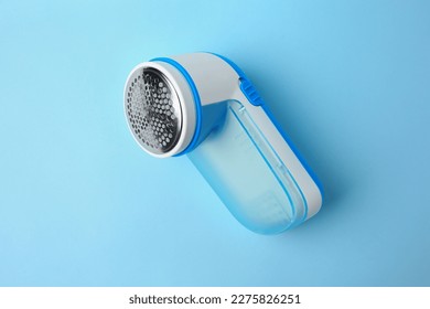 Modern fabric shaver on light blue background, top view - Shutterstock ID 2275826251