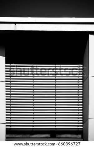 Two windows with closed shutters