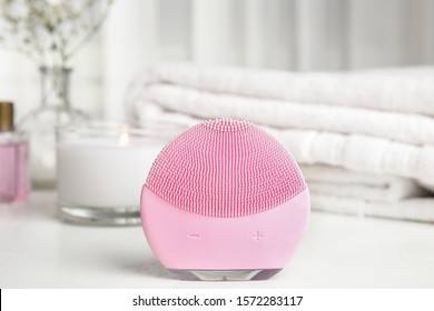 Modern Face Cleansing Brush On White Table. Cosmetic Accessory
