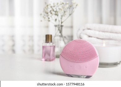 Modern Face Cleansing Brush On White Table. Cosmetic Accessory