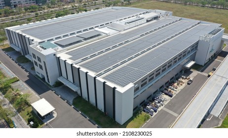 Modern factory building with roof mounted solar system - Shutterstock ID 2108230025