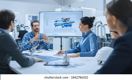 Modern Factory Office Meeting Room: Diverse Team of Engineers, Managers and Investors Talking at Conference Table, Use Interactive TV, Analyze Sustainable Energy Engine Blueprints. High-Tech Facility - Shutterstock ID 1842786352