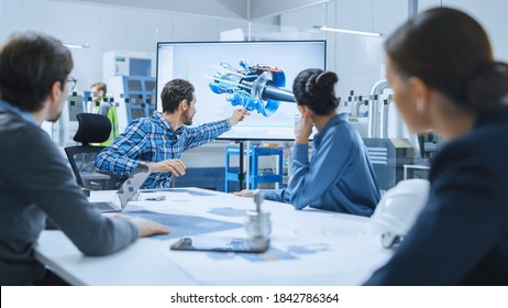 Modern Factory Office Meeting Room: Diverse Team Of Engineers, Managers And Investors Talking At Conference Table, Use Interactive TV, Analyze Sustainable Energy Engine Blueprints. High-Tech Facility