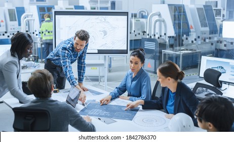 Modern Factory Office Meeting Room: Busy Diverse Team Of Engineers, Managers And Investors Talking At Conference Table, Use Interactive TV, Analyze, Find Solutions, Debate And Discuss Engine Concept