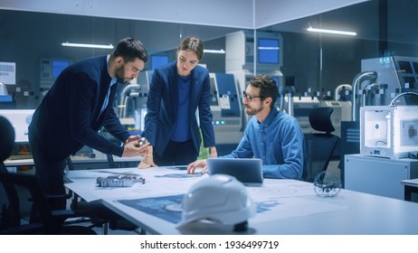 Modern Factory Office Meeting Room: Diverse Team of Engineers, Managers Talking at Conference Table, Look at Blueprints, Inspect Mechanism, Use Laptop. High-Tech Facility with CNC Machines - Shutterstock ID 1936499719