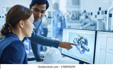 Modern Factory Office: Portrait of Male Project Supervisor Talking with a Female Industrial Engineer, They Point at Computer Display Showing CAD Software with 3D Engine Concept. Team Problem Solving