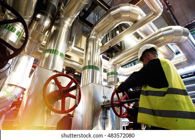 modern factory worker turning valve