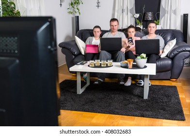 Modern family in front of tv