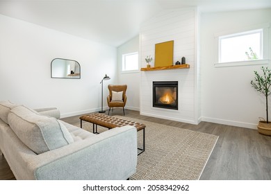 Modern Farmhouse Simple Living Room With Minimal Decor Gas Fireplace With A Raw Edge Wooden Mantel Brown Leather Armchair And Sofa