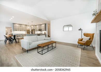 Modern Farmhouse Simple Living Room With Minimal Decor Gas Fireplace With A Raw Edge Wooden Mantel Brown Leather Armchair And Sofa