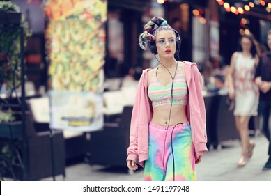 Modern fashion vanguard woman on the streets with trendy eyeglasses and piercings, listening music on headphones - Unique Avant-garde confident young woman - Urban fashion - Shutterstock ID 1491197948