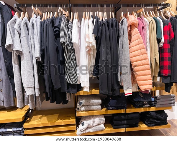 Modern fashion women clothes hang on\
stanless steel hangers rack at clothing store department store.\
Casual clothes online\
shopping.\
\
