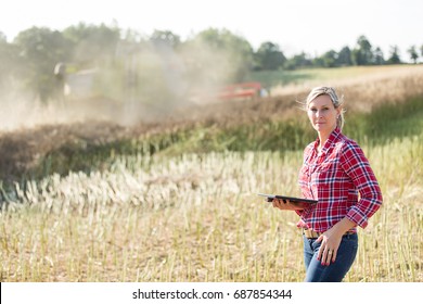 Modern female farmer in field. She is strong, hard worker and gritty.