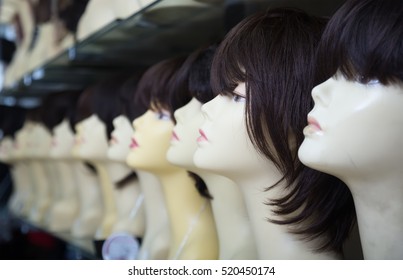 Modern Female Mannequins With Wigs On Shelves Of Hair Salon 