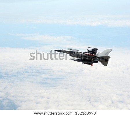 Modern fighter jet flying at high altitude