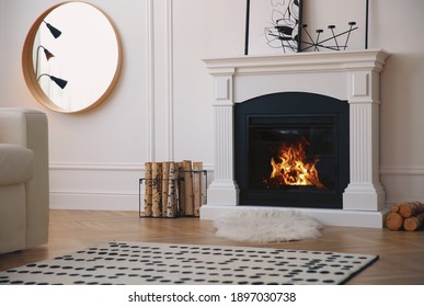 Modern fireplace with burning wood in room. Interior design