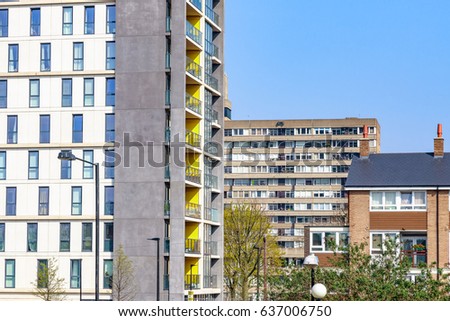 Modern flats in contrast to old council housing blocks