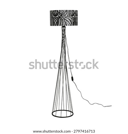Modern floor lamp with zebra pattern lampshade and minimalist black metal wireframe stand isolated on light background